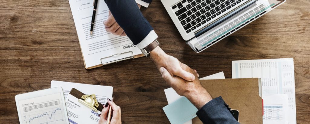Business people shaking hands together